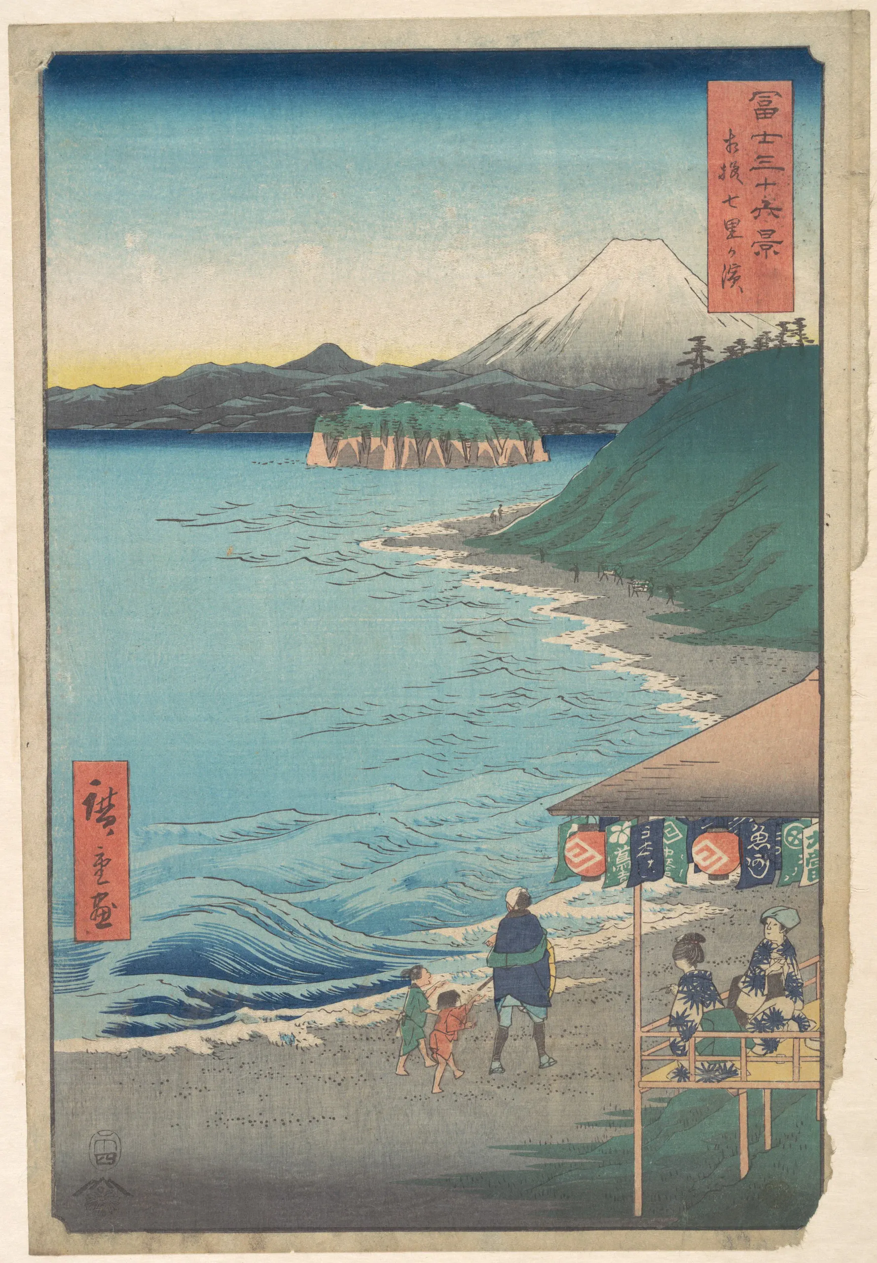 A color Japanese woodblock landscape print shows Mount Fuji rising behind a rippled lake, a small wooded island, and a curving sandy shoreline. Three foreground visitors walk beside the water, while two people sit at a raised market stall or viewing platform on the right. Several tiny figures appear farther along the shore. Vertical red cartouches contain Japanese writing.