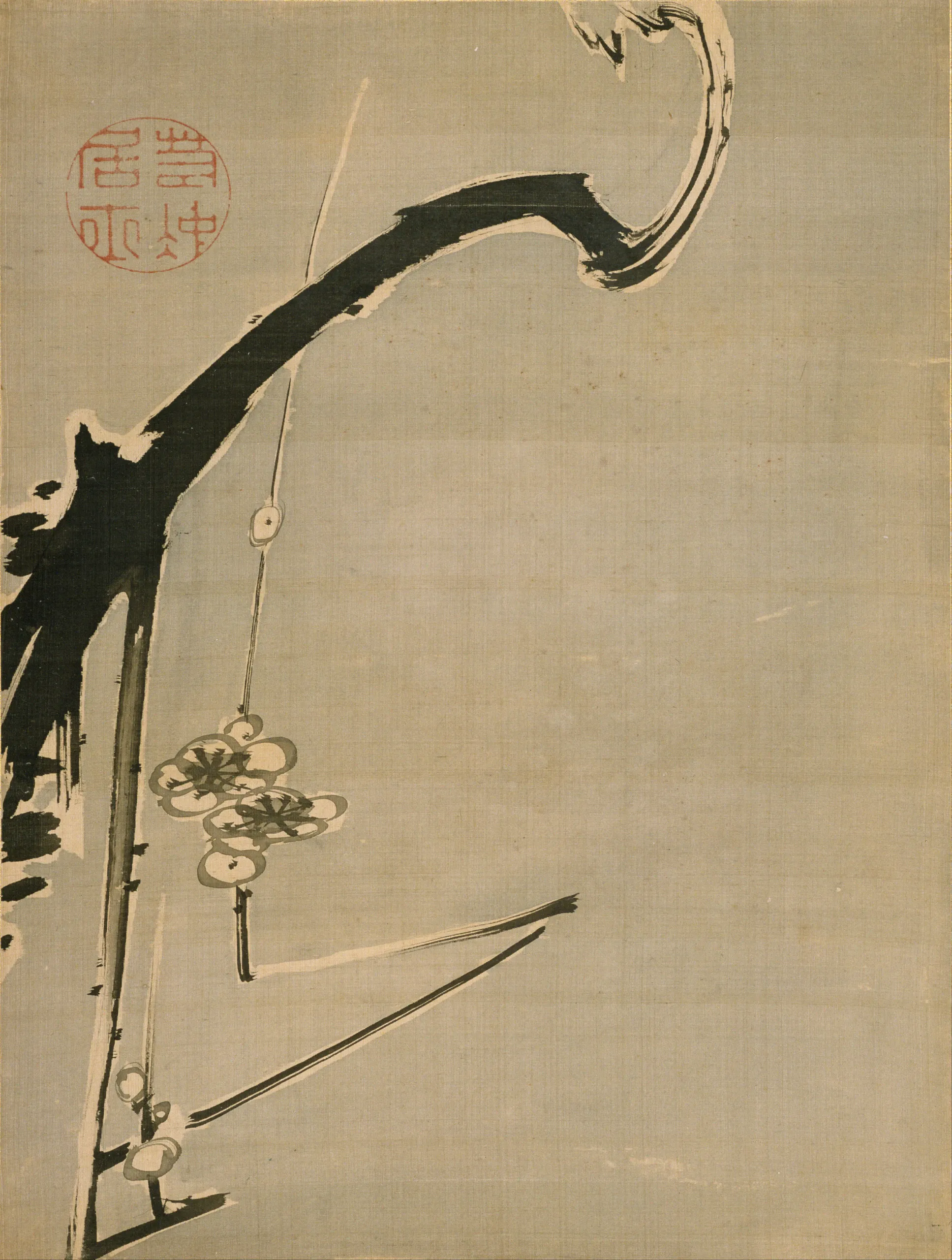 A vertical brush-and-ink painting shows a heavy black, gnarled tree trunk and branch rising diagonally from the lower left and curling toward the upper right. Sparse hanging flower or foliage clusters descend from thin stems against a large, empty beige paper background; a red circular seal appears near the upper left.